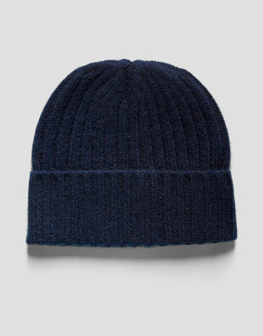 Navy blue knit beanie on a light gray background